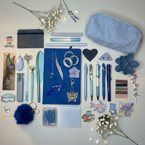Calm and refreshing blue bundle flatlay with white flowers, pebbles, and lavender accents