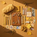 Warm and inviting golden yellow flatlay bundle with journal, pens, charms, and accessories
